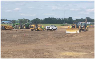 tractors leveling ground at construction site