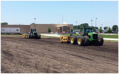 tractors leveling ground at construction site