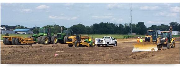 tractors leveling ground at construction site